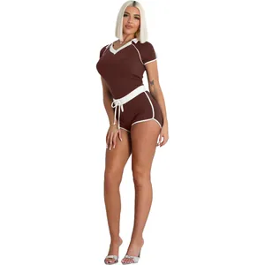 Brown V-neck two-piece athletic set with white contrast trim and elastic fabric