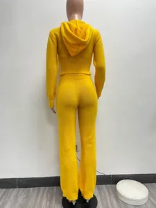 Back view of a yellow knitted hooded two-piece set on a mannequin for urban fashion