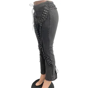 Detailed side view of high waist stretch denim pants with metal eyelets and lacing details.