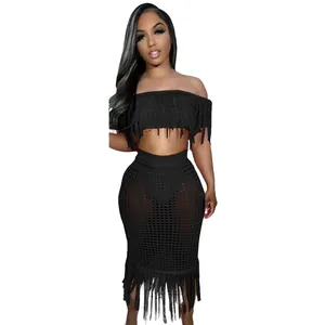 Detail of black crochet two-piece beach set with stylish fringe trim details.