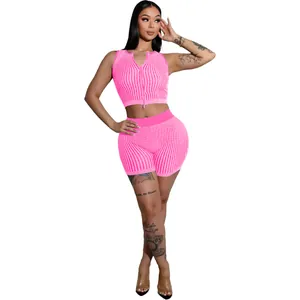Detailed view of women's neon pink knitted two-piece set with two-way zipper