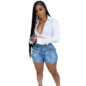 Detailed view of women's washed blue denim cargo shorts with large 3D pockets