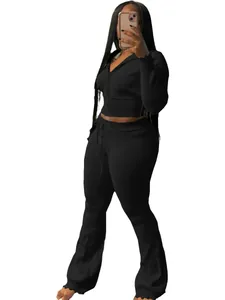 Chic black two-piece knit tracksuit featuring zip-up hoodie and flared pants