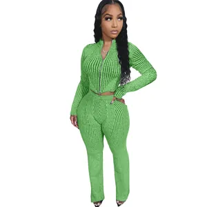 Detailed view of women's two-piece green ribbed knit set with double zipper top.