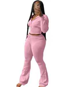 Fashionable pink knitted two-piece sports suit for women featuring a zip-up hoodie