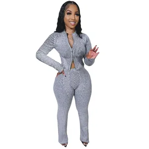 Model wearing a grey ribbed knit two-piece set with a two-way zipper top and pants.