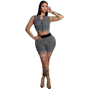 Detail view of women's two-piece knit set featuring a double zipper top and shorts
