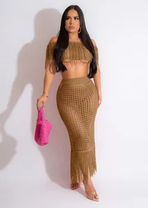 Close-up of brown crochet beach set showing fringe details and transparent knit texture