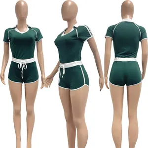 Front, side, and back views of a green two-piece athletic set with white trim.