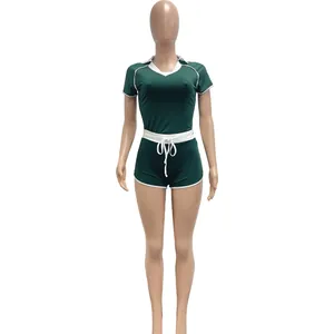 Women's dark green two-piece yoga sports set with V-neck top and shorts, white trim detail