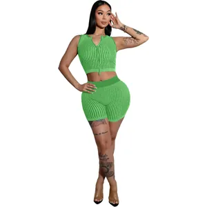 Detailed view of women's green ribbed knit two-piece set with a functional two-way zipper