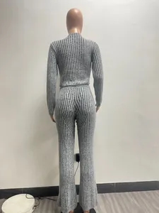 Back view of a grey and black striped women's knitted sweater and flare pants set