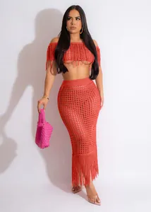 Detailed view of a sexy coral crochet beach two-piece set with long tassel skirt.