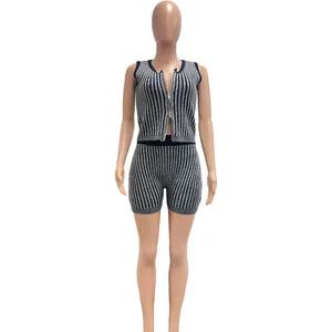 Detail of women's two-piece knit set with two-way zipper and striped shorts