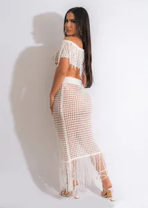 Detailed back view of white crochet two-piece beach set with fringe and open knit design