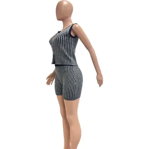 Side view detail of a women's black and white vertical striped knitted two-piece set outfit
