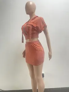 Side profile view of orange acid wash vintage hooded top and mini skirt two-piece set