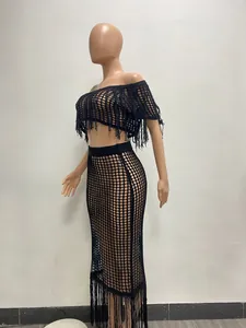 Two-piece black crochet see-through beach set with fringe detail on a mannequin