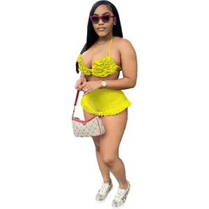 Detailed view of yellow two-piece set with ruffled halter top and matching shorts