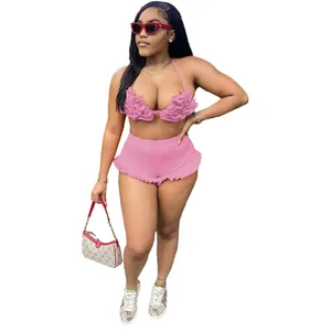Detailed view of sexy pink two-piece set with ruffled halter top and matching shorts
