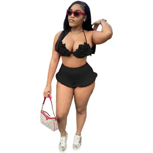 Fashionable black ruffled two-piece set with halter top and high-waisted shorts