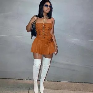 Full length detail of sexy orange sleeveless dress with lace-up eyelet corset style and pleats