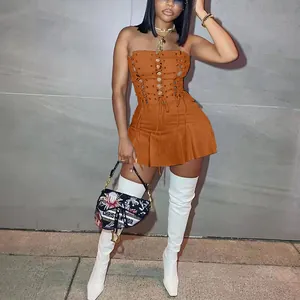 Detail of a sexy orange lace-up sleeveless mini dress featuring unique eyelet design
