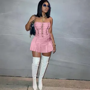 Detail view of a sexy pink sleeveless lace-up mini dress with eyelet corset design.