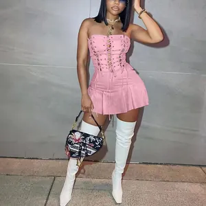 Close-up of a pink lace-up strapless mini dress with elegant pleated skirt details