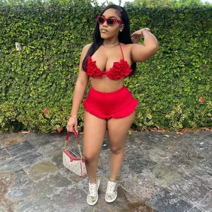 Detailed view of red ruffled halter top and high-waisted shorts set on model