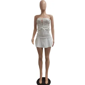 Fashionable white strapless mini dress featuring lace-up eyelet details on a mannequin stand