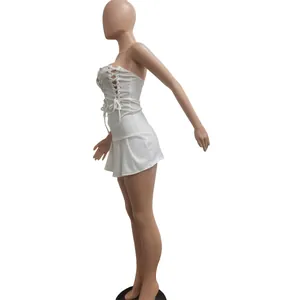 Detailed side view of a sexy white lace-up sleeveless mini dress on a mannequin