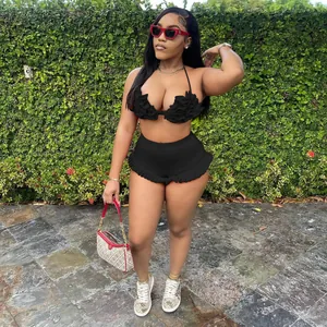 Close-up of sexy black halter neck ruffled top and matching high-waisted shorts set