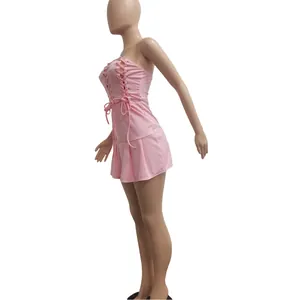 Side view of a sexy pink lace-up strapless mini dress featuring a stylish pleated hemline