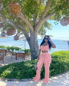 Ensemble de plage sexy rose à franges crocheté à la main porté par un mannequin en vacances