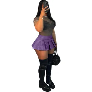 Purple faux leather pleated mini skirt styled with mesh top and over-the-knee boots.