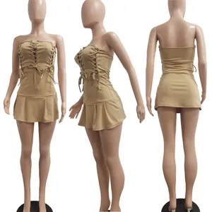 Multi-angle views of a beige strapless lace-up mini dress with a pleated hem detail