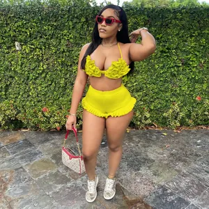 Fashionable yellow ruffle two-piece set with halter top and high-waisted shorts