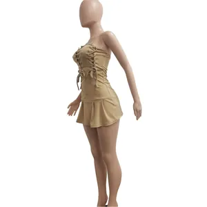 Side view of khaki strapless mini dress with lace-up details and pleated skirt