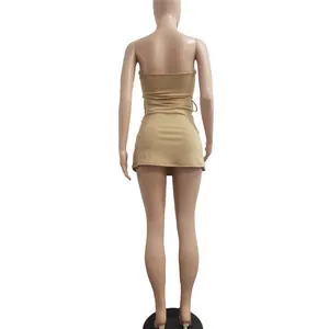 Rear view of a sexy strapless bodycon mini dress in tan color with side eyelet details