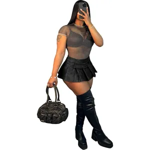 Close-up of a sexy black faux leather pleated mini skirt for women in a studio shot
