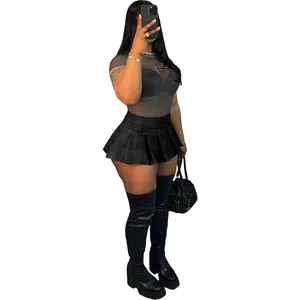 Full model view of a black sexy faux leather pleated mini skirt with mesh top and boots