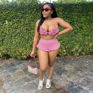Full body detail of a sexy pink two-piece ruffle set with a halter top and shorts