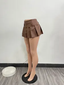 Detail side view of a stylish brown faux leather pleated mini skirt on a mannequin