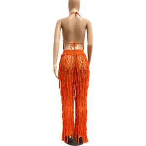 Vue arrière détaillée d'un ensemble de plage sexy à pompons en crochet orange ajouré