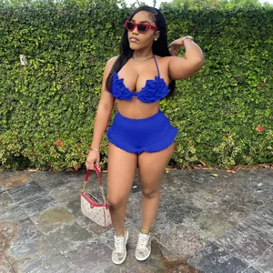 Detail view of a sexy blue ruffle halter top and shorts set on a model outdoors