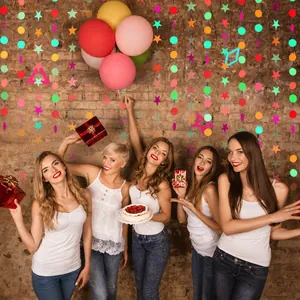 Colorful neon star and circle paper garlands displayed in a festive birthday party setting.