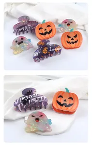 Collection of festive Halloween hair clips with pumpkin and ghost motifs on white fabric