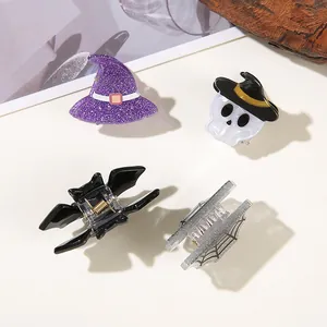 Close-up of Halloween themed hair clips with witch hat, skull, bat and web designs.