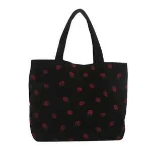 Cute black corduroy tote bag with red strawberry print for daily commute and school